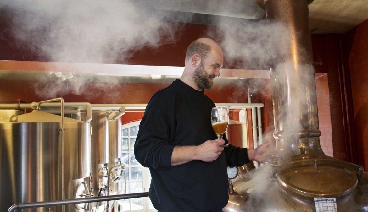 Prague Microbrewery with man Checking brew