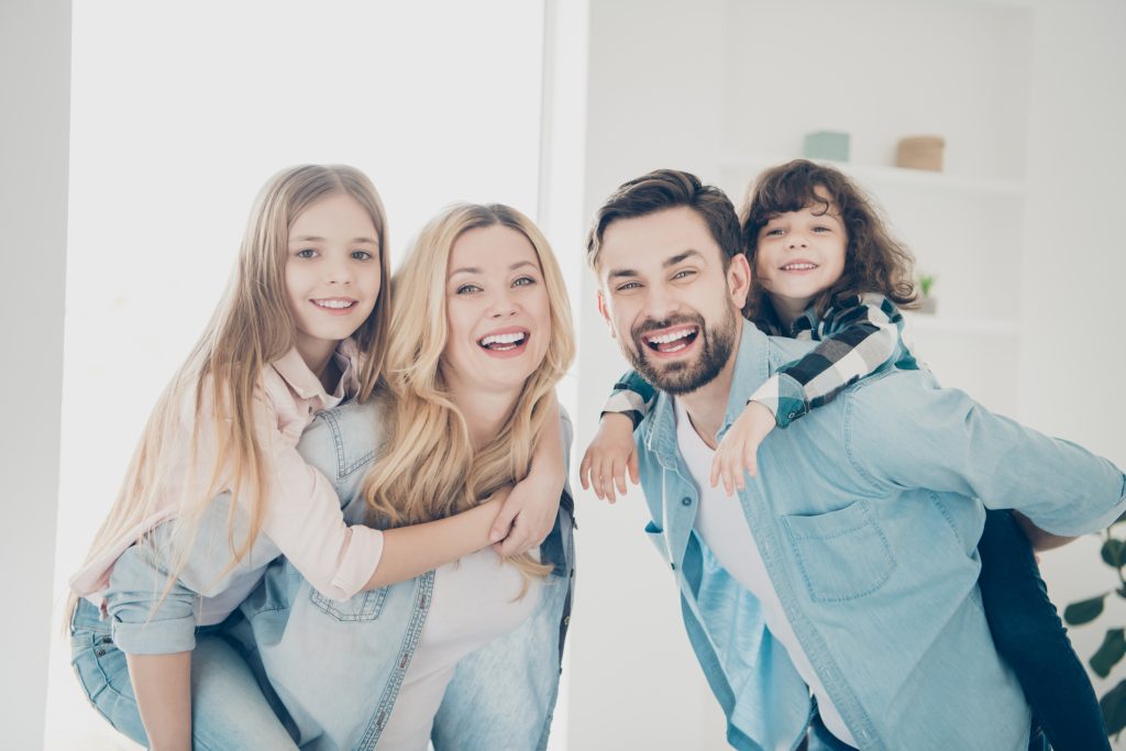 Photo of big family four members hugging